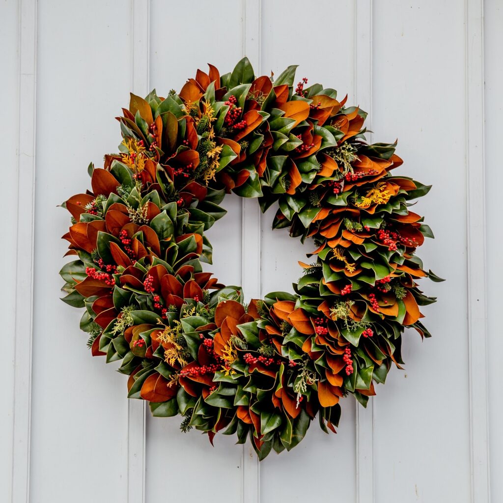 A wreath of leaves hanging on the side of a building.