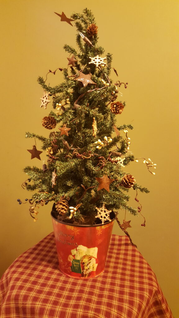 A small christmas tree with decorations on it