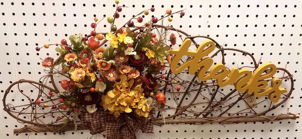 A wreath with flowers and berries on it.