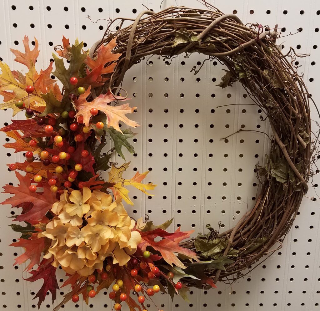 A wreath with leaves and berries on it.