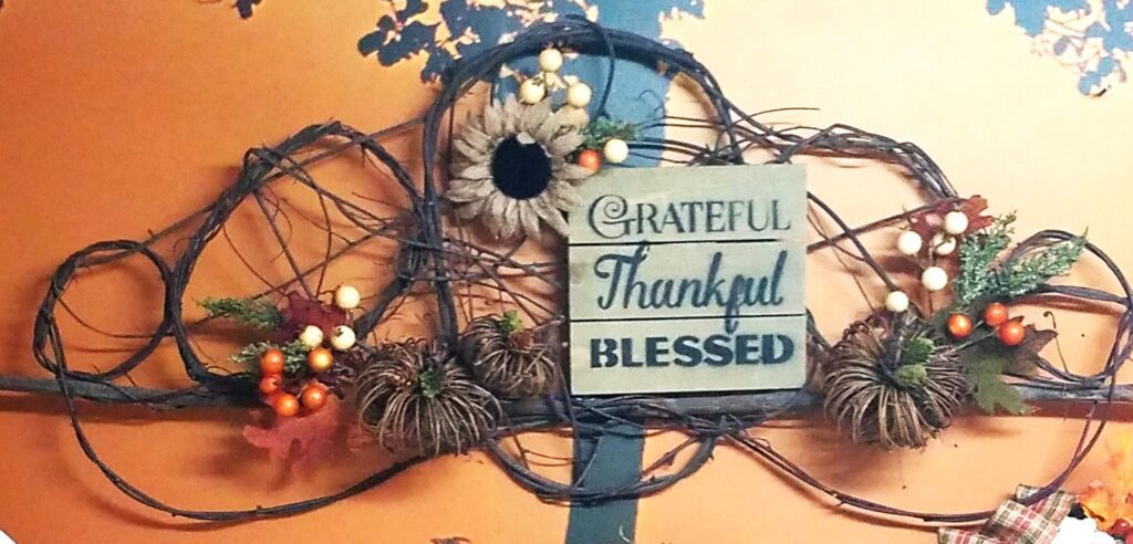 A wreath with a sign that says grateful thankful blessed.