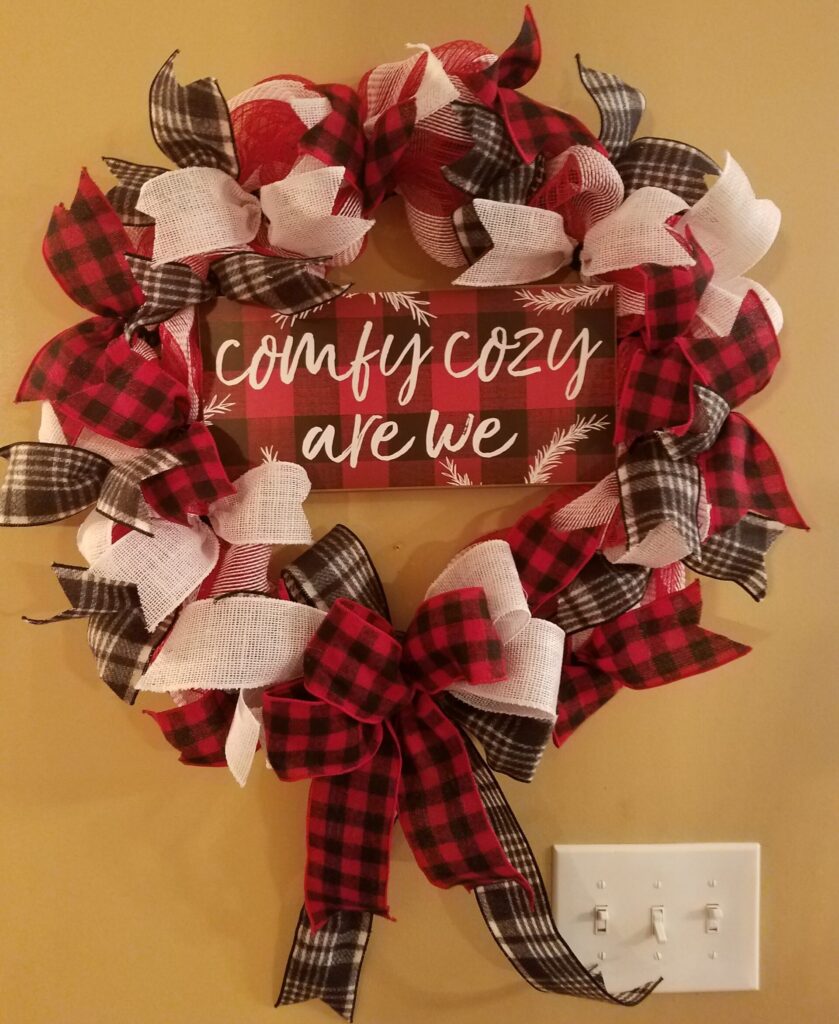 A wreath that has words written on it.