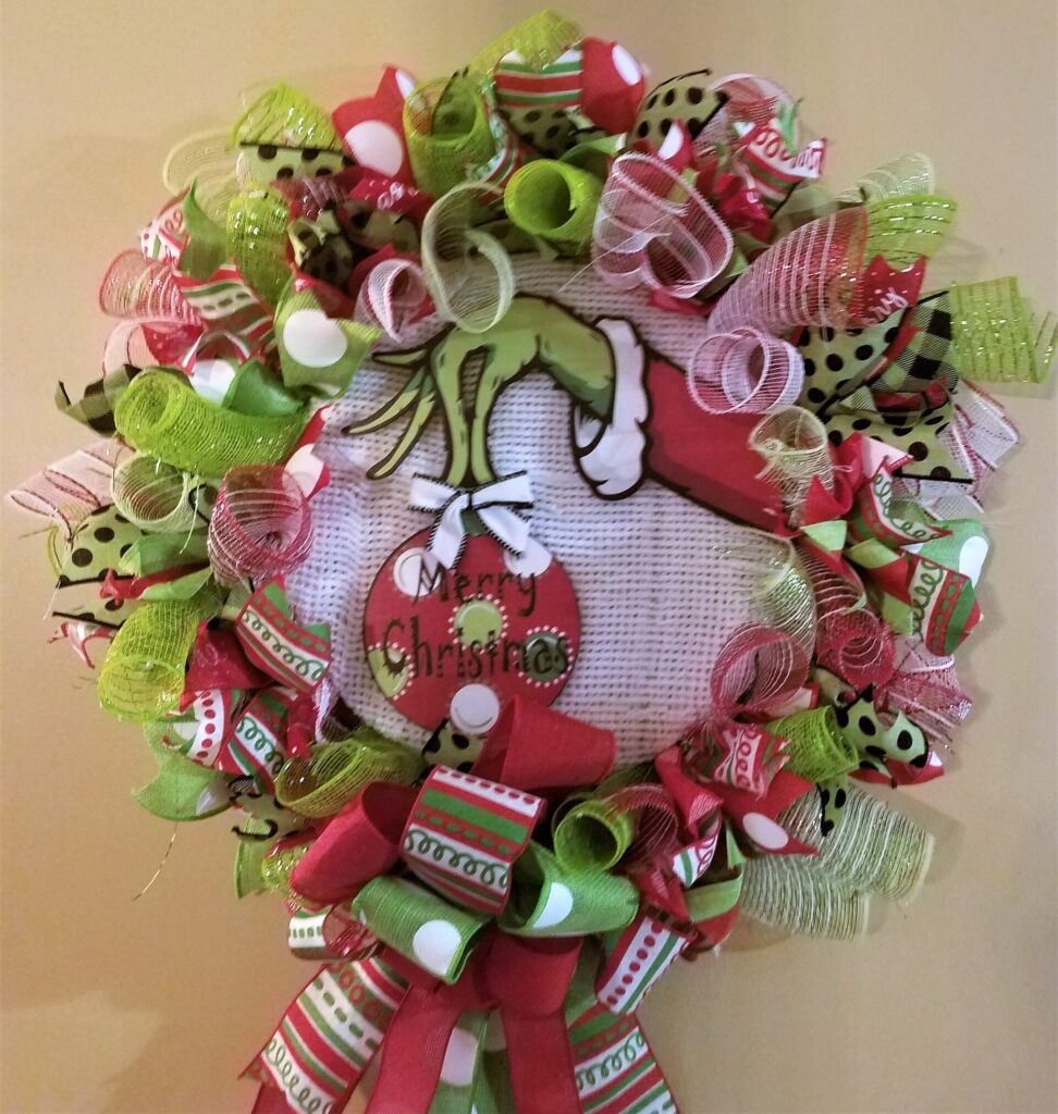 A christmas wreath with lots of ribbons and bows.