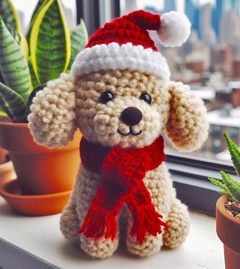 A crocheted dog with a santa hat and scarf.