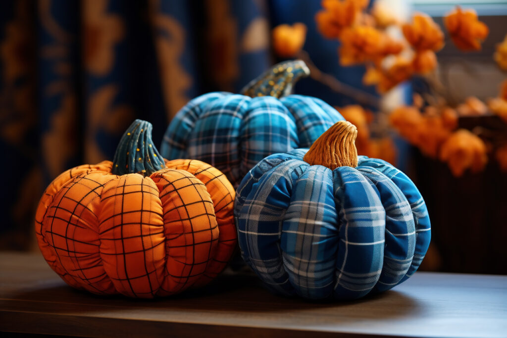 Three pumpkins are sitting on a table with other items.