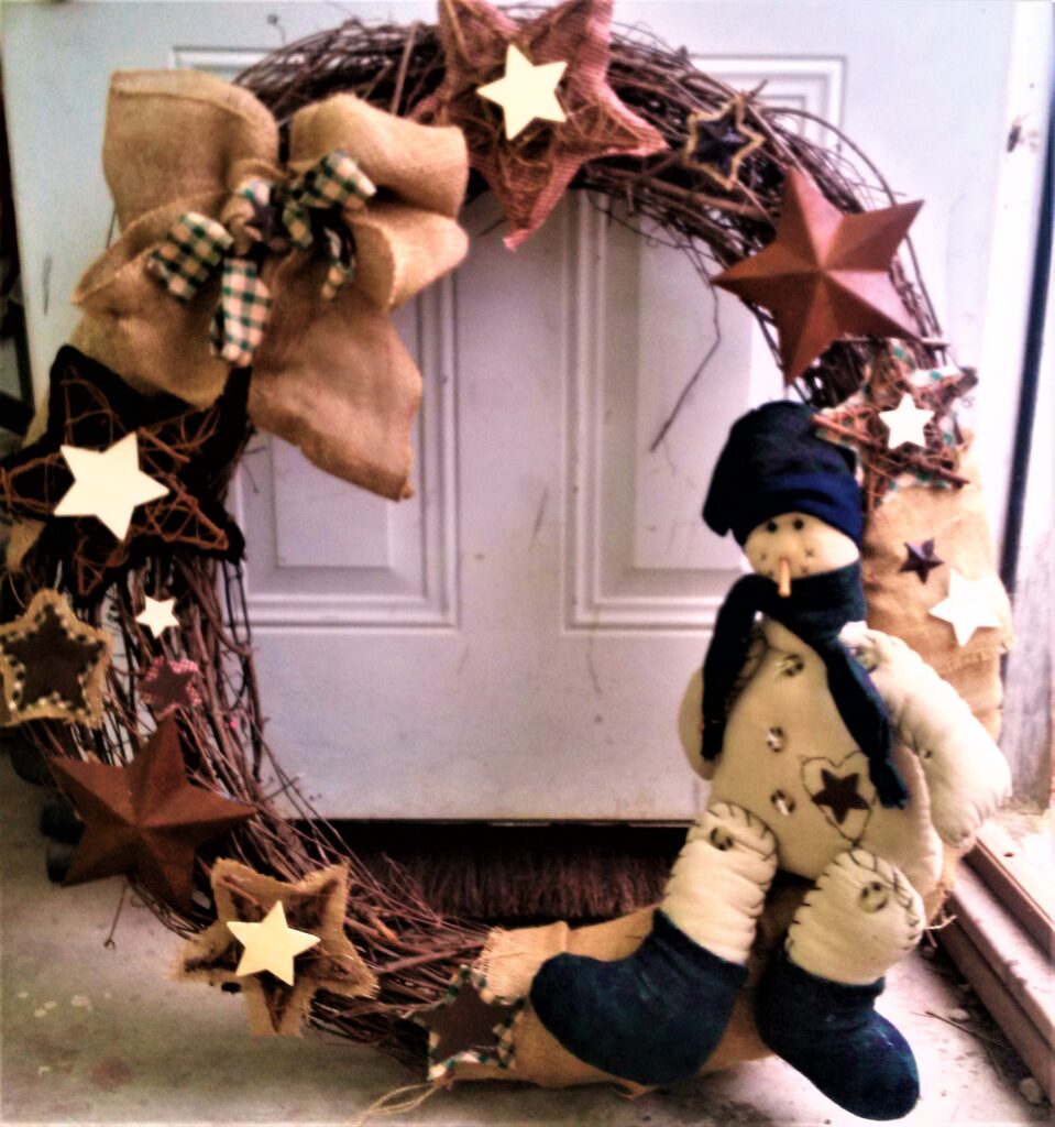 A wreath with stars and a stuffed animal on it.