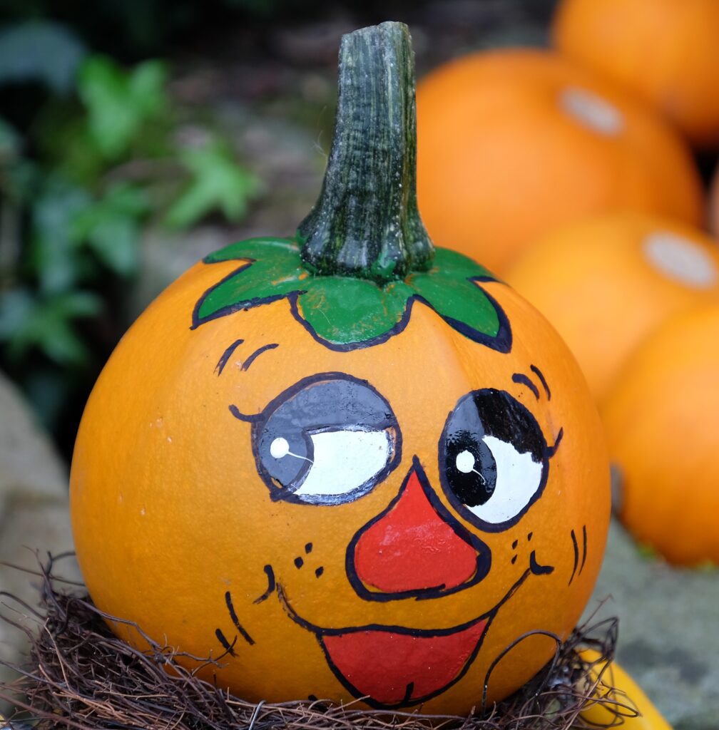 A pumpkin with faces drawn on it