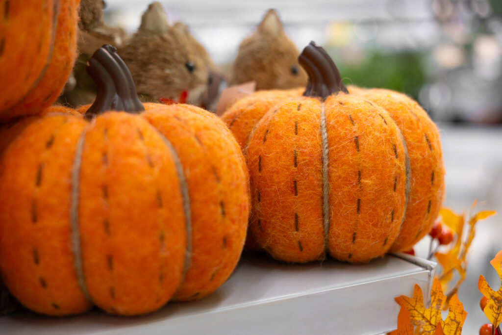 A couple of stuffed pumpkins sitting on top of a table.