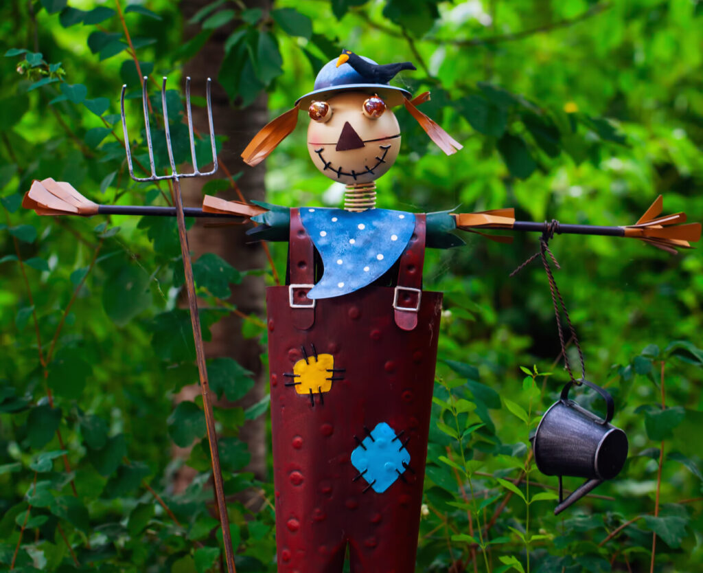 A scarecrow with an apron and hat on.