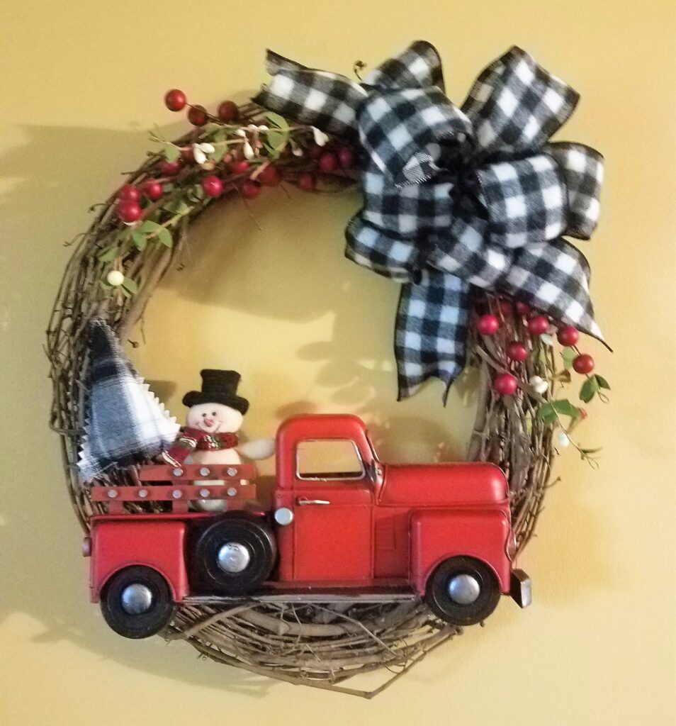 Christmas wreath: snowman in red truck.