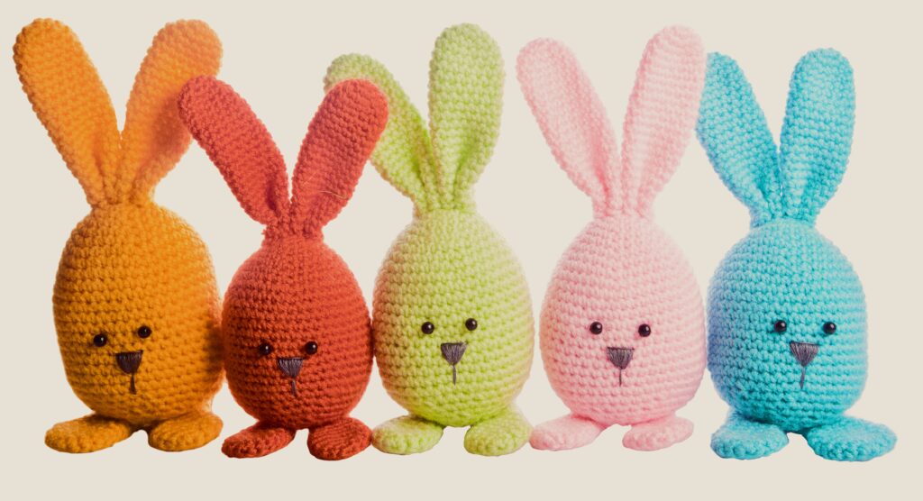 Four colorful crocheted Easter bunnies.