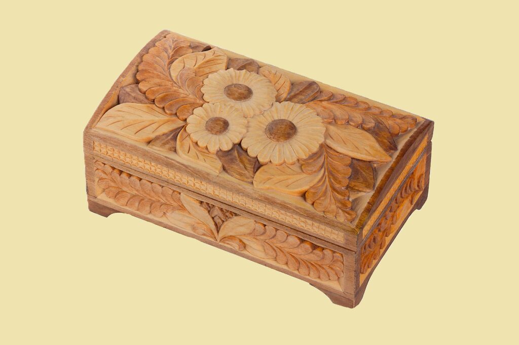 Ornate wooden box with floral carvings.