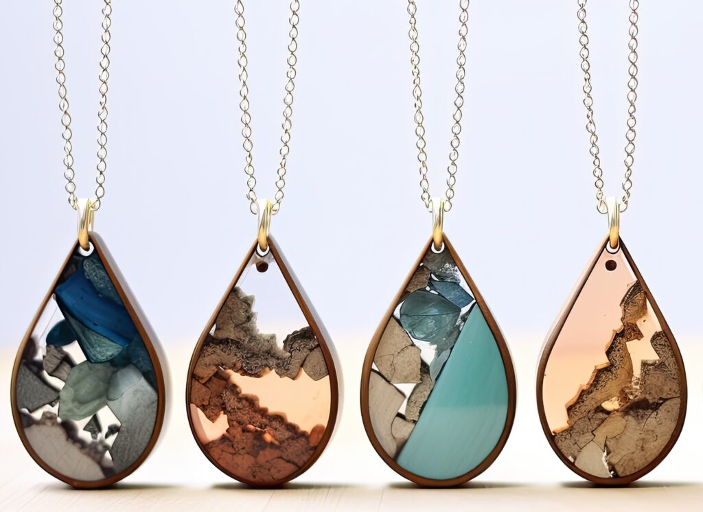 Four teardrop resin necklaces.