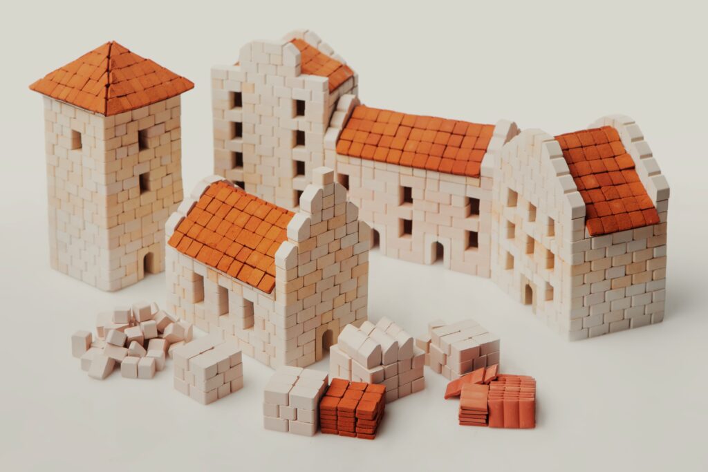 Miniature brick buildings under construction.