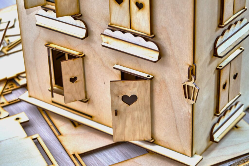 Wooden dollhouse with heart details.