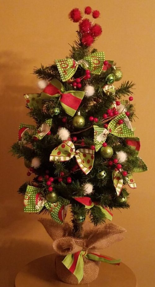 A christmas tree with green and red decorations.