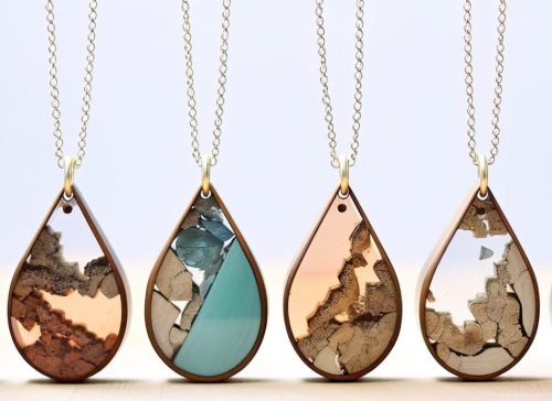 Three necklaces with different designs of wood and metal.