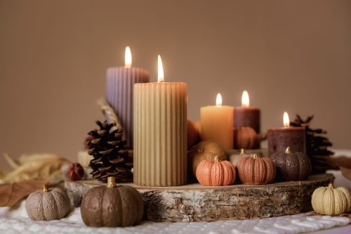 A table with candles and pumpkins on it